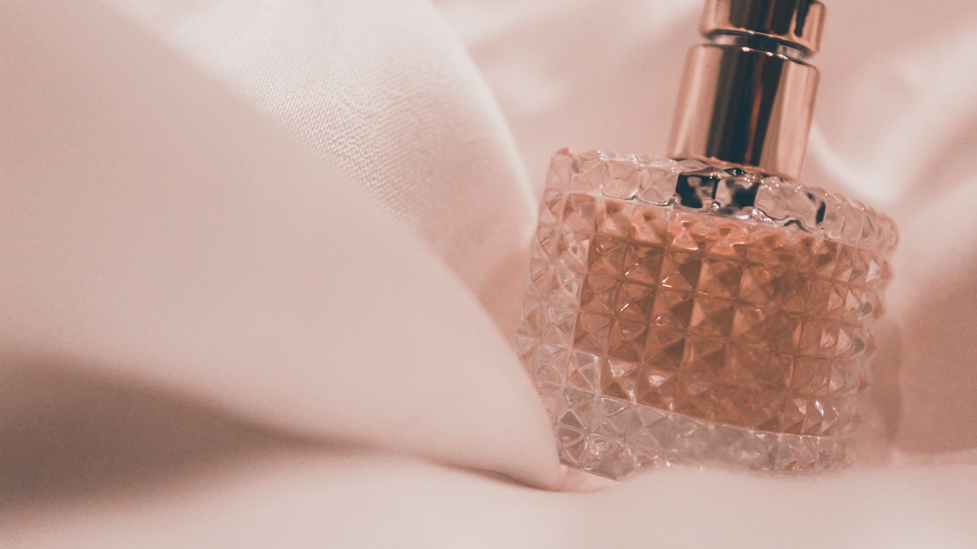Luxury perfume bottles on a soft neutral surface